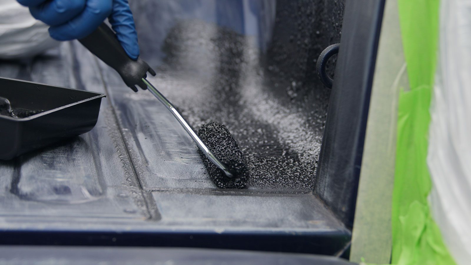 using a roller to apply truck bed liner